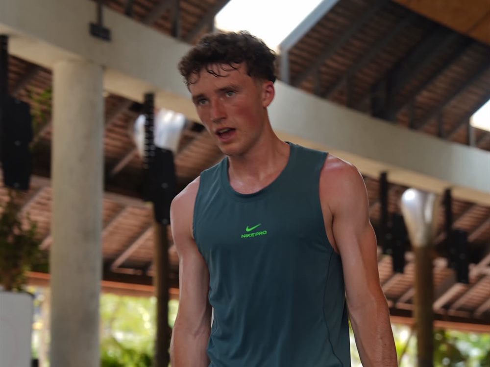 Luke Ennis carrying kettlebells during a training session