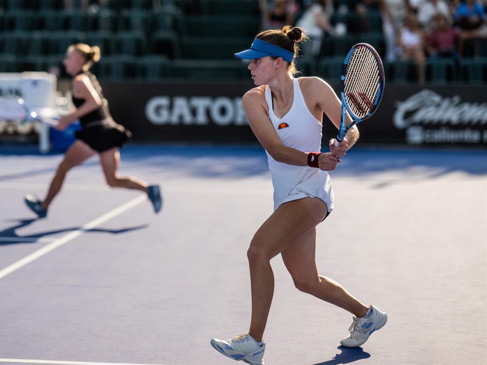 Maia Lumsden playing a backhand during a professional tennis match