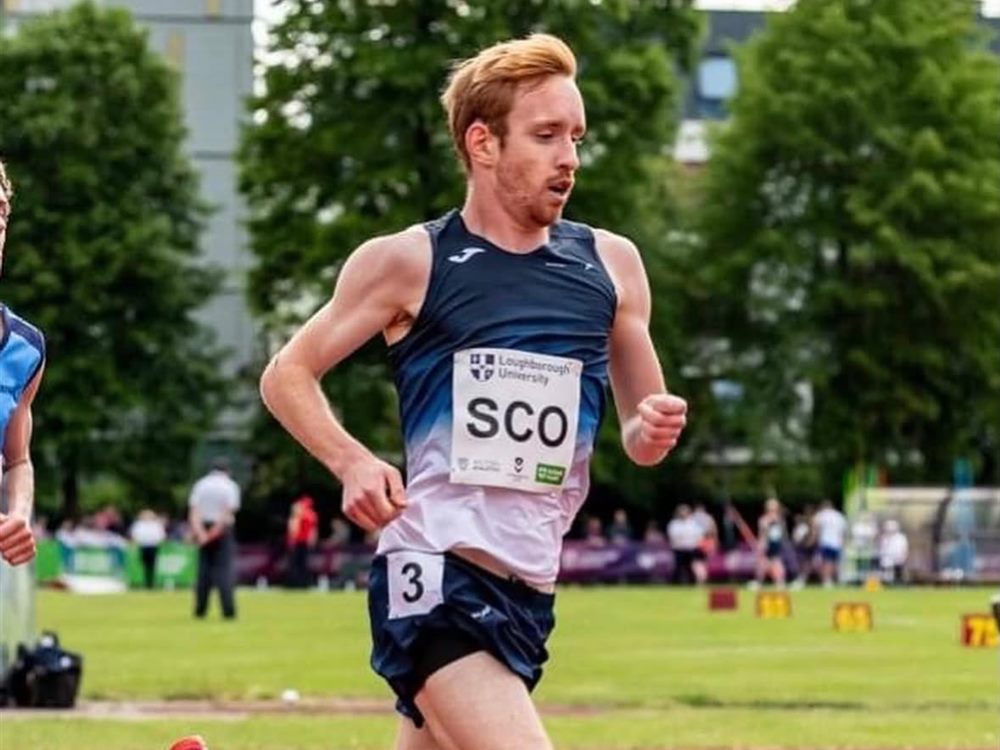 Ryan Thomson racing on the track in a Scotland vest